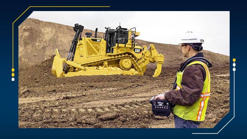 Operator controls bulldozer remotely outdoors.
