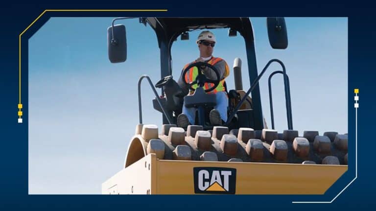 Operator driving a yellow construction vehicle