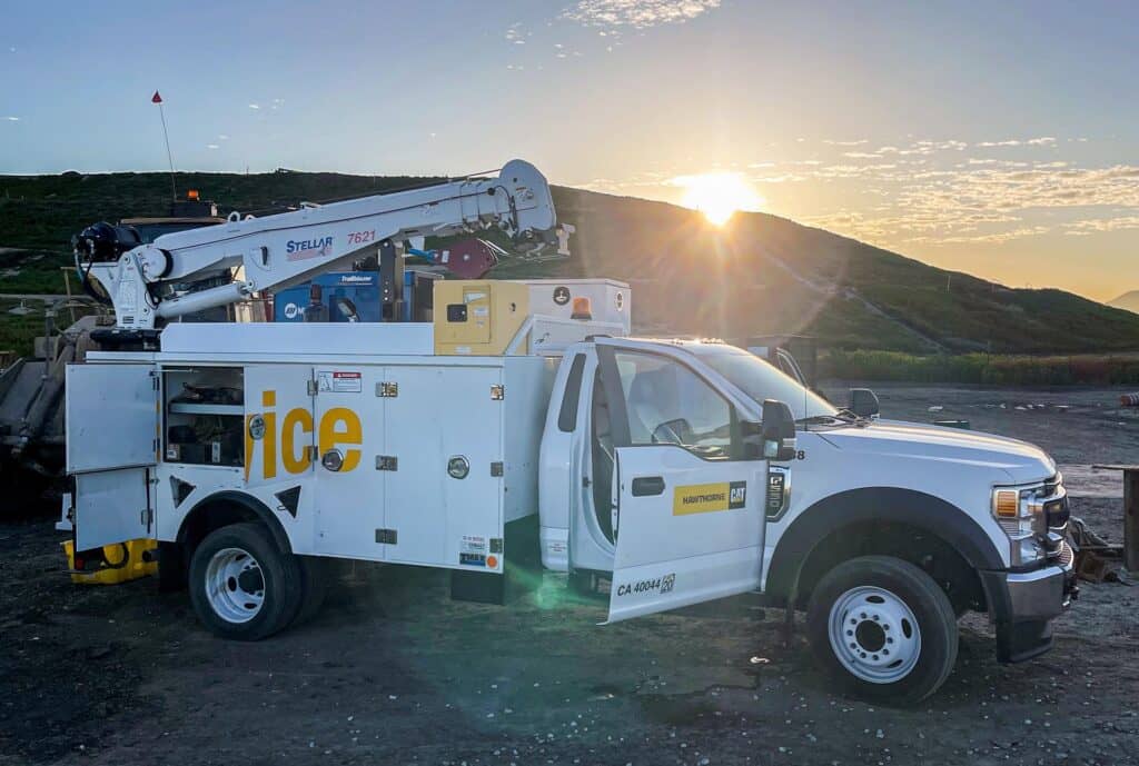 Utility truck at sunrise on hill